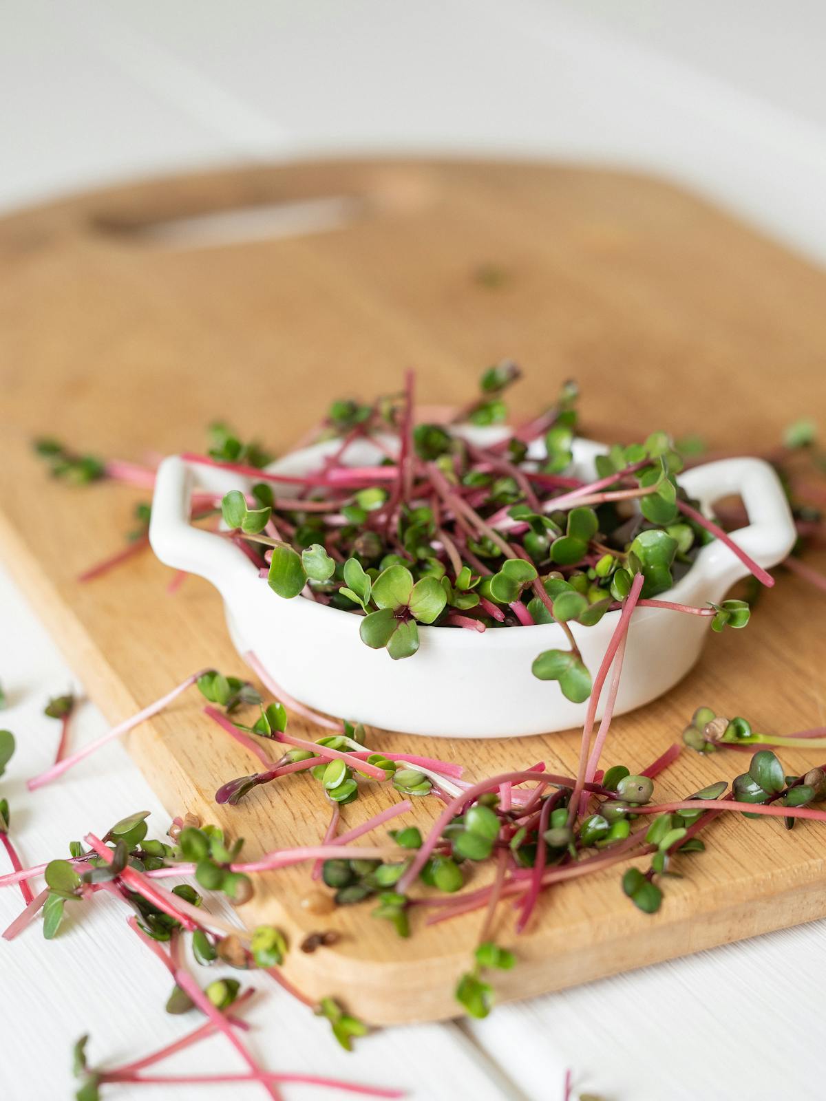 Crisp radish microgreen sprouts on a wooden board